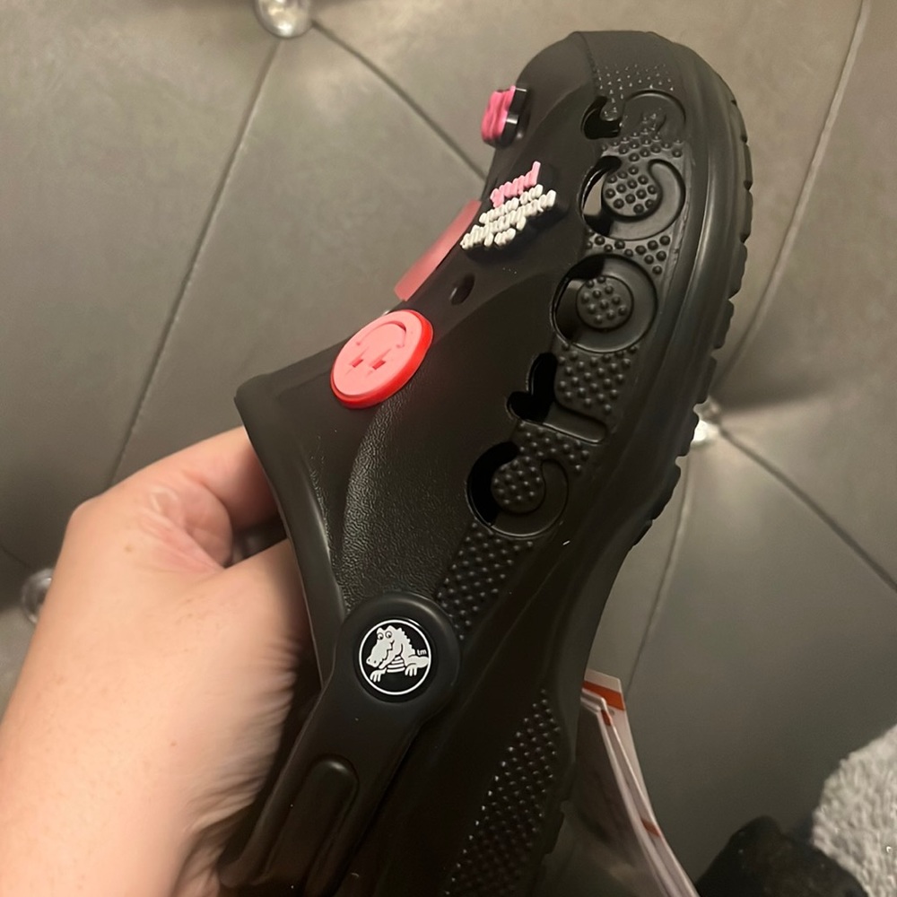 Crocs black with all pink charms